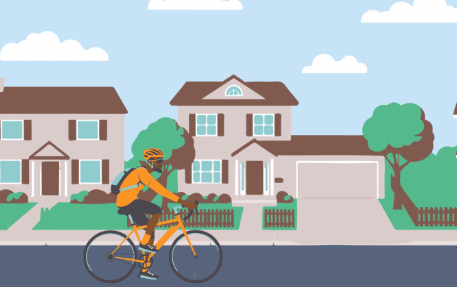 image of cyclist riding in neighborhood